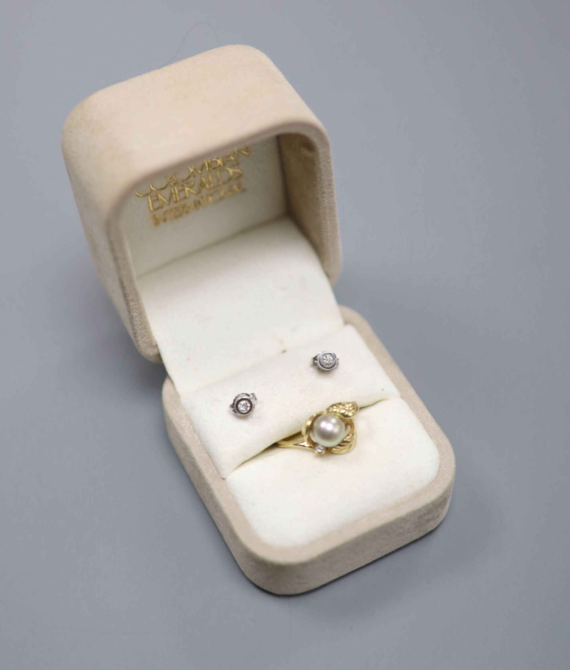 A modern yellow metal (stamped 14k), cultured pearl and diamond chip set dress ring, & pair of earstuds.